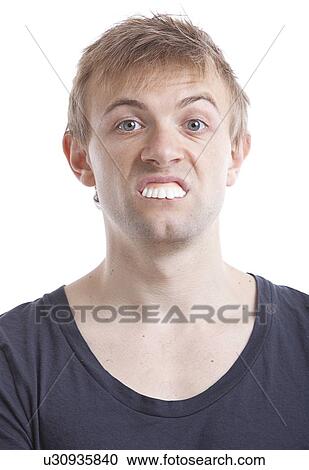 Portrait of young man with fake teeth against white background View Large Photo Image Stock Image - Portrait of young man with fake teeth against white background. Fotosearch