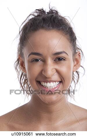 Portrait of young Mixed Race woman smiling against white background View Large Photo Image Stock Image - Portrait of young Mixed Race woman smiling against white background. Fotosearch