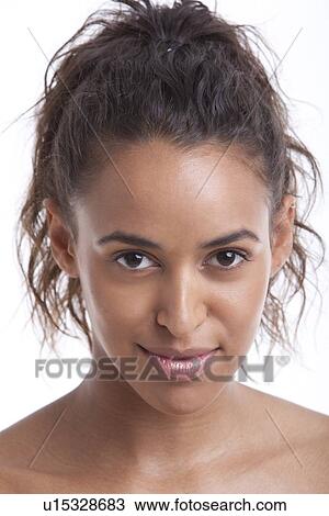 Stock Image - Portrait of young Mixed Race woman smiling against white background. Fotosearch