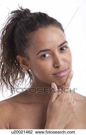 Portrait of young Mixed Race woman thinking with hand on chin against white background View Large Photo Image Stock Image - Portrait of young Mixed Race woman thinking with hand on chin against white background. Fotosearch