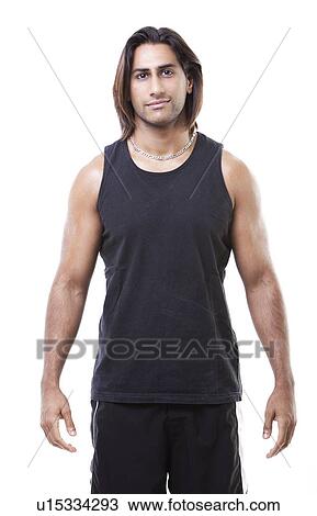 Portrait of young muscular man standing over white background View Large Photo Image Stock Image - Portrait of young muscular man standing over white background. Fotosearch