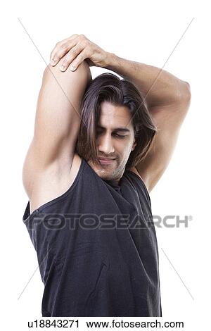 Portrait of young muscular man stretching his arms over white background View Large Photo Image Stock Image - Portrait of young muscular man stretching his arms over white background. Fotosearch