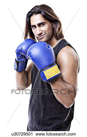 Portrait of young muscular man wearing boxing gloves over white background View Large Photo Image Stock Image - Portrait of young muscular man wearing boxing gloves over white background. Fotosearch