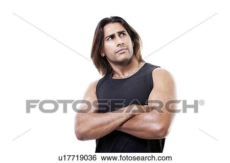 Portrait of young muscular man with arms crossed standing over white background View Large Photo Image Stock Photograph - Portrait of young muscular man with arms crossed standing over white background. Fotosearch