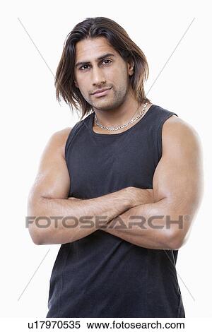 Portrait of young muscular man with arms crossed standing over white background View Large Photo Image Stock Photography - Portrait of young muscular man with arms crossed standing over white background. Fotosearch