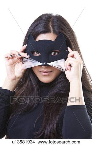 Portrait of young woman wearing cat mask against white background View Large Photo Image Picture - Portrait of young woman wearing cat mask against white background. Fotosearch