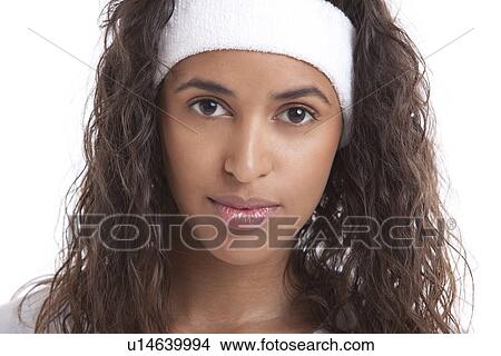 Picture - Portrait of young woman with headband against white background. Fotosearch