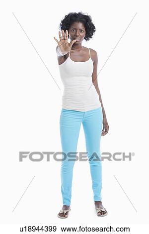 Portrait of young woman with stop gesture standing over white background View Large Photo Image Stock Photo - Portrait of young woman with stop gesture standing over white background. Fotosearch