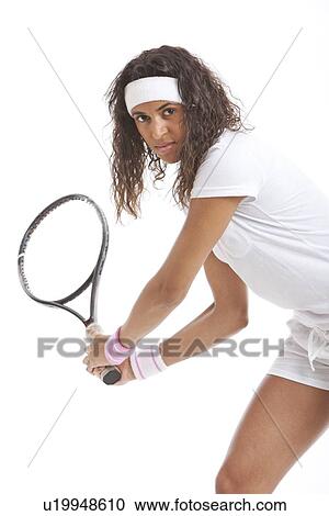 Portrait of young woman with tennis racket against white background View Large Photo Image Stock Image - Portrait of young woman with tennis racket against white background. Fotosearch