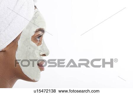 Profile shot of young Mixed Race woman with face pack against white background View Large Photo Image Stock Photo - Profile shot of young Mixed Race woman with face pack against white background. Fotosearch