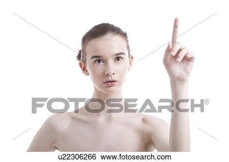 Shirtless beautiful young woman pointing up against white background View Large Photo Image Stock Photograph - Shirtless beautiful young woman pointing up against white background. Fotosearch