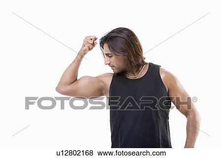 Young Asian man flexing muscles over white background View Large Photo Image Stock Photo - Young Asian man flexing muscles over white background. Fotosearch
