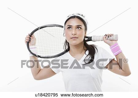 Young Asian woman holding tennis racket over white background View Large Photo Image Stock Photography - Young Asian woman holding tennis racket over white background. Fotosearch