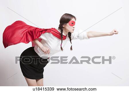 Young Asian woman pretending to be a superhero against white background View Large Photo Image Stock Photo - Young Asian woman pretending to be a superhero against white background. Fotosearch