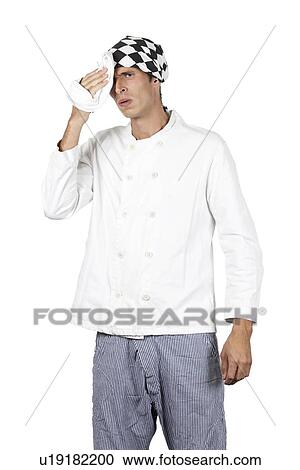 Young chef rubs sweat of his brow View Large Photo Image Stock Image - Young chef rubs sweat of his brow. Fotosearch
