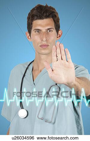 Stock Photograph - Young doctor holding hand to camera with Electrocardiogram on base of image. Fotosearch