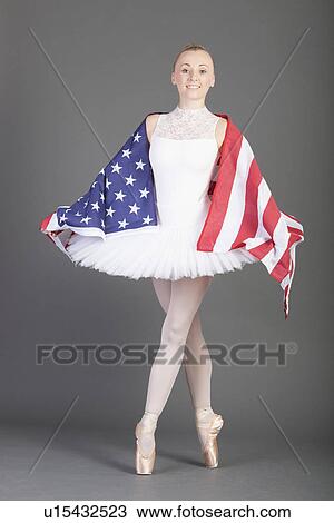 Young female ballet dancer dancing wearing American flag over grey background View Large Photo Image Stock Image - Young female ballet dancer dancing wearing American flag over grey background. Fotosearch