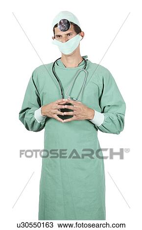 Young surgeon stands wearing mask, head mirror and stethoscope View Large Photo Image Stock Image - Young surgeon stands wearing mask, head mirror and stethoscope. Fotosearch