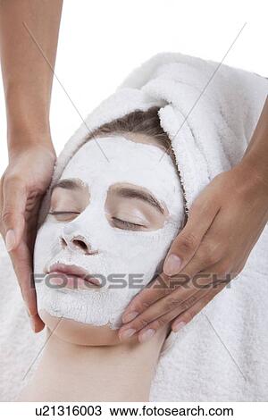 Young woman receiving facial treatment at spa View Large Photo Image Stock Image - Young woman receiving facial treatment at spa. Fotosearch