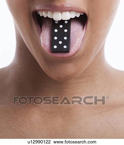 Young woman with domino on tongue against white background View Large Photo Image Stock Image - Young woman with domino on tongue against white background. Fotosearch