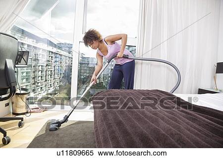 African American woman vacuuming in bedroom View Large Photo Image Stock Photography - African American woman vacuuming in bedroom. Fotosearch