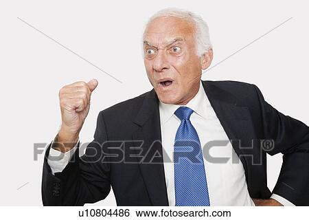 Aggressive elderly businessman against white background View Large Photo Image Stock Photograph - Aggressive elderly businessman against white background. Fotosearch