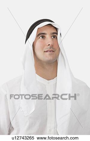 An Arab businessman looking away against white background View Large Photo Image Stock Photography - An Arab businessman looking away against white background. Fotosearch