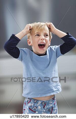 Angry Caucasian boy in casuals tearing his hair out View Large Photo Image Stock Image - Angry Caucasian boy in casuals tearing his hair out. Fotosearch