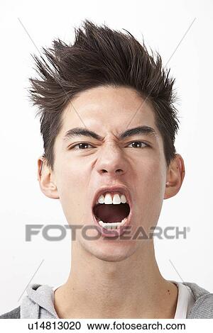 Angry young man screaming against white background View Large Photo Image Stock Image - Angry young man screaming against white background. Fotosearch