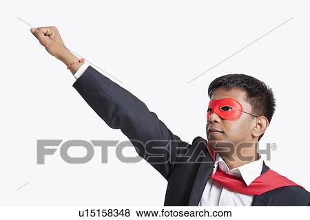 Asian businessman pretending to be a superhero against white background View Large Photo Image Stock Photo - Asian businessman pretending to be a superhero against white background. Fotosearch