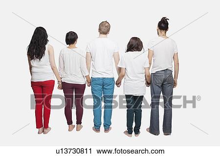 Back view of young multi-ethnic friends in casuals holding hands over white background View Large Photo Image Stock Image - Back view of young multi-ethnic friends in casuals holding hands over white background. Fotosearch