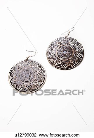 Stock Image - Beautiful design on earrings over white background. Fotosearch