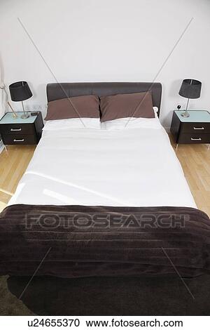 Bed and night tables in bedroom View Large Photo Image Stock Image - Bed and night tables in bedroom. Fotosearch