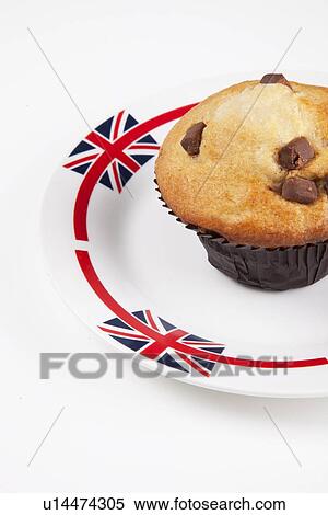 Stock Photography - Close-up of cupcake on plate over white background. Fotosearch