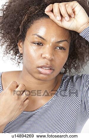 Close-up of tired young woman looking away View Large Photo Image Stock Photo - Close-up of tired young woman looking away. Fotosearch