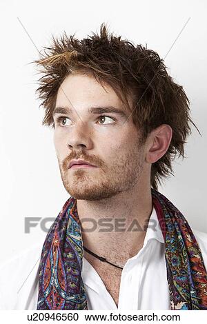 Close-up of young man thinking against white background View Large Photo Image Stock Image - Close-up of young man thinking against white background. Fotosearch