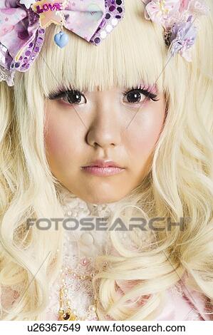 Close-up portrait of cute woman in doll costume over purple background View Large Photo Image Stock Photo - Close-up portrait of cute woman in doll costume over purple background. Fotosearch