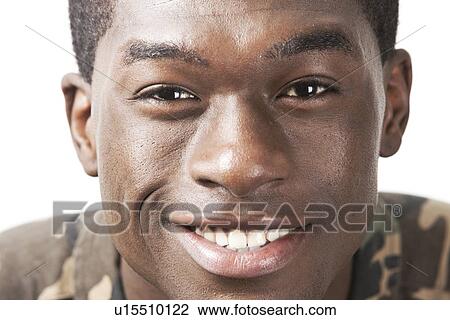 Close-up portrait of happy young man against white background View Large Photo Image Stock Image - Close-up portrait of happy young man against white background. Fotosearch
