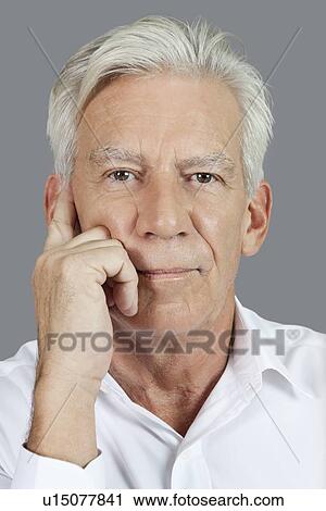 Close-up portrait of senior man thinking over gray background View Large Photo Image Stock Image - Close-up portrait of senior man thinking over gray background. Fotosearch
