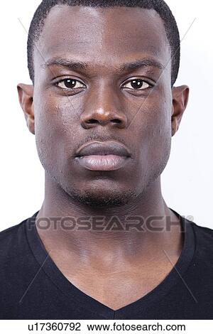 Stock Image - Close-up portrait of young African American man against white background. Fotosearch