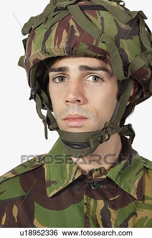 Close-up portrait of young soldier against gray background View Large Photo Image Stock Photograph - Close-up portrait of young soldier against gray background. Fotosearch
