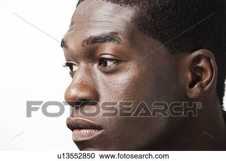 Close-up shot of thoughtful young man looking away against white background View Large Photo Image Stock Image - Close-up shot of thoughtful young man looking away against white background. Fotosearch