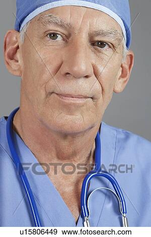 Close-up view of senior male surgeon over gray background View Large Photo Image Stock Photo - Close-up view of senior male surgeon over gray background. Fotosearch