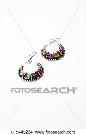 Picture - Colorful gems on earrings over white background. Fotosearch