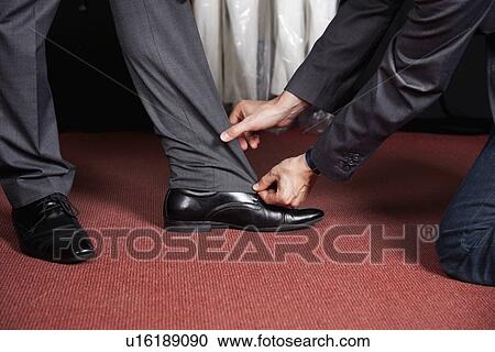 Cropped image of tailor measuring man's trouser View Large Photo Image Stock Image - Cropped image of tailor measuring man's trouser. Fotosearch