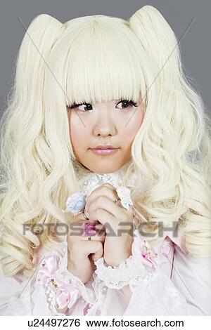 Cute young woman dressed as a doll over gray background View Large Photo Image Stock Photograph - Cute young woman dressed as a doll over gray background. Fotosearch