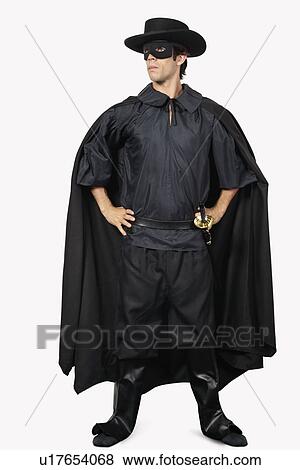 Full length of young man dressed as Zorro against gray background View Large Photo Image Stock Photo - Full length of young man dressed as Zorro against gray background. Fotosearch