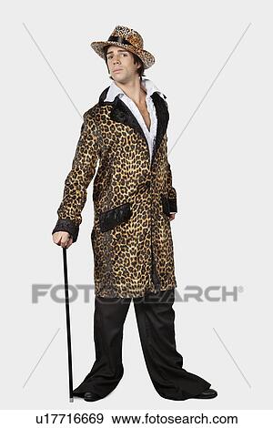 Full length of young man in fur clothing against gray background View Large Photo Image Stock Photo - Full length of young man in fur clothing against gray background. Fotosearch