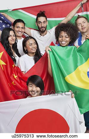 Stock Image - Group of multi-ethnic friends holding various national flags against white background. Fotosearch