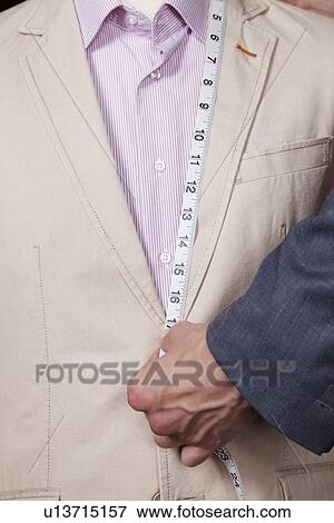 Hand measuring suit length with tape View Large Photo Image Stock Photo - Hand measuring suit length with tape. Fotosearch